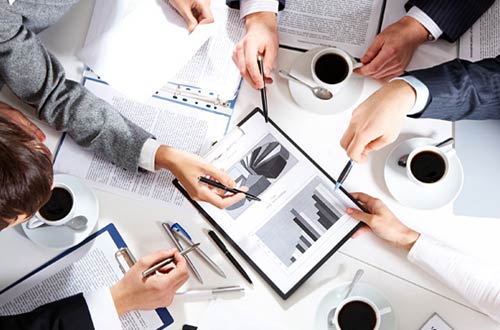 Team looking at computer in a meeting